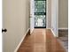 Inviting entryway featuring hardwood floors, neutral paint, and an ornamental security door at 115 Creek Cir, Stockbridge, GA 30281