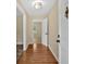 Inviting entryway featuring hardwood floors, neutral paint, and ample natural light streaming through an adjacent room at 115 Creek Cir, Stockbridge, GA 30281