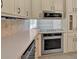 Kitchen with light-colored countertops and stainless steel appliances including dishwasher and oven at 115 Creek Cir, Stockbridge, GA 30281