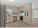 Kitchen with stainless steel dishwasher, oven, microwave, and light-colored cabinets and tile flooring at 115 Creek Cir, Stockbridge, GA 30281