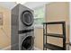 Laundry room featuring a new stacked washer and dryer with window at 115 Creek Cir, Stockbridge, GA 30281