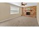 Living room featuring a window, plush carpeting and brick fireplace as a focal point at 115 Creek Cir, Stockbridge, GA 30281