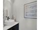 Modern bathroom with a vessel sink, black faucet, round mirror, and contemporary decor at 2030 Main Nw St # 205, Atlanta, GA 30318