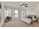 Spacious primary bedroom with ceiling fan, large windows, and plush carpet at 2030 Main Nw St # 205, Atlanta, GA 30318