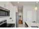 Modern kitchen features stainless steel appliances, white cabinets, and an island with countertop seating at 2030 Main Nw St # 205, Atlanta, GA 30318