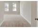 Neutral room with carpet, two windows, baseboards, and walls ready for design at 2030 Main Nw St # 205, Atlanta, GA 30318