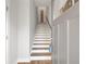 Interior staircase with hardwood treads and white risers at 2030 Main Nw St # 205, Atlanta, GA 30318