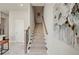 Carpeted staircase with wood railings and modern artwork creates an inviting entryway at 2030 Main Nw St # 205, Atlanta, GA 30318