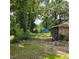 View of backyard featuring a detached structure, showcasing the lot's potential at 3547 Pleas Dr, Ellenwood, GA 30294