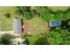 Aerial view of home, lush landscaping, large yard, and a swimming pool at 5 Citation Ct, Ellenwood, GA 30294