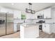 Bright kitchen featuring white cabinets, stainless steel appliances and an island with seating at 5 Citation Ct, Ellenwood, GA 30294