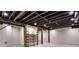 Unfinished basement area with exposed ceiling beams, painted brick walls, and wooden supports at 2189 Cedar Forks Dr, Marietta, GA 30062
