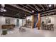 Finished basement area with open ceiling, modern decor, and comfortable seating at 2189 Cedar Forks Dr, Marietta, GA 30062