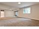 Spacious carpeted basement with natural light from a sliding glass door and window at 2189 Cedar Forks Dr, Marietta, GA 30062