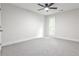 Spacious bedroom featuring carpeted floors, ceiling fan, and a window showcasing natural light at 2189 Cedar Forks Dr, Marietta, GA 30062