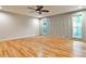 Bright bedroom featuring hardwood floors, a ceiling fan, and two windows with custom wall trim at 2189 Cedar Forks Dr, Marietta, GA 30062