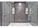 Luxurious tiled shower with a unique herringbone pattern, dual shower heads, and built-in shelves at 2189 Cedar Forks Dr, Marietta, GA 30062