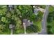 A beautiful home with mature trees and lush landscaping viewed from above, near a well-maintained road at 24 Lady Savannah Dr, Dallas, GA 30157