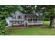 Charming two-story home features a inviting front porch, complemented by neatly landscaped yard and mature trees at 24 Lady Savannah Dr, Dallas, GA 30157