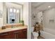 Well-lit bathroom featuring a vanity with a marble countertop and a shower with a tub at 4561 Olde Perimeter Way # 806, Dunwoody, GA 30346