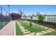 A well-maintained dog park with artificial turf, stepping stones, and a white picket fence in a pet-friendly community at 4561 Olde Perimeter Way # 806, Dunwoody, GA 30346