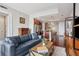 Inviting living space with hardwood floors, a kitchen island, and a comfortable blue sofa at 4561 Olde Perimeter Way # 806, Dunwoody, GA 30346