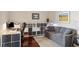 A spacious living room with a desk and shelving, and comfortable seating area with a large rug at 4561 Olde Perimeter Way # 806, Dunwoody, GA 30346