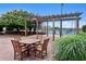 Outdoor patio featuring a pergola, brick paving, and a table with four chairs for outdoor relaxation at 4561 Olde Perimeter Way # 806, Dunwoody, GA 30346