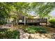 Inviting backyard with spacious deck, lush landscaping, and tranquil outdoor space for relaxation at 1100 Tuxedo Dr, Roswell, GA 30075