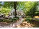 Backyard featuring a covered porch, patio, and well-maintained landscaping at 1100 Tuxedo Dr, Roswell, GA 30075