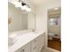 Modern bathroom with white cabinets, countertop, large mirror, and stylish lighting fixture at 1100 Tuxedo Dr, Roswell, GA 30075