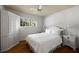 Classic bedroom with hardwood floors, matching nightstands, and white bedding at 1100 Tuxedo Dr, Roswell, GA 30075