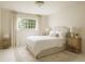 This bedroom is brightly lit and includes matching end tables, lamps, and a white rug at 1100 Tuxedo Dr, Roswell, GA 30075