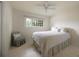Bright bedroom featuring a ceiling fan, large window, and a comfortable bed with white bedding at 1100 Tuxedo Dr, Roswell, GA 30075