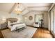 Bright main bedroom features vaulted ceilings, a chandelier, and access to the backyard at 1100 Tuxedo Dr, Roswell, GA 30075
