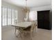 Dining room with a vintage chandelier, shutters, and light-colored hardwood flooring at 1100 Tuxedo Dr, Roswell, GA 30075