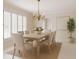 Bright dining room featuring elegant light fixture and plantation shutters at 1100 Tuxedo Dr, Roswell, GA 30075