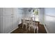 Charming dining area with wainscoting, hardwood floors, and natural light at 1100 Tuxedo Dr, Roswell, GA 30075