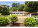 Charming single-story home featuring a white picket fence and mature landscaping at 1100 Tuxedo Dr, Roswell, GA 30075