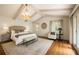 Spacious main bedroom features a decorative chandelier and hardwood flooring at 1100 Tuxedo Dr, Roswell, GA 30075