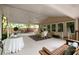Covered deck with ample seating, ceiling fans, and scenic backyard view at 1100 Tuxedo Dr, Roswell, GA 30075