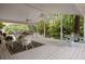 Spacious covered deck with multiple seating areas, ideal for outdoor entertaining at 1100 Tuxedo Dr, Roswell, GA 30075