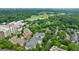 Aerial view of condo community amidst green trees and golf course in distance at 50 Biscayne Nw Dr # 4110, Atlanta, GA 30309