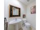 Classic bathroom with pedestal sink, artistic mirror and framed artwork at 50 Biscayne Nw Dr # 4110, Atlanta, GA 30309