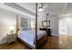 Bright bedroom featuring a four poster bed, hardwood floors, and ensuite bathroom with soaking tub at 50 Biscayne Nw Dr # 4110, Atlanta, GA 30309