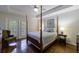 Sunlit bedroom featuring a four poster bed and french doors with access to the outdoor balcony at 50 Biscayne Nw Dr # 4110, Atlanta, GA 30309