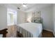 Bright bedroom features hardwood floors, ceiling fan, and ensuite bathroom with neutral color palette at 50 Biscayne Nw Dr # 4110, Atlanta, GA 30309