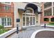 Elegant building entrance with awning, glass doors, and manicured landscaping at 50 Biscayne Nw Dr # 4110, Atlanta, GA 30309