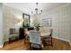 Cozy dining room with hardwood floors, stylish wallpaper, and a classic chandelier over the round table at 50 Biscayne Nw Dr # 4110, Atlanta, GA 30309