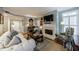 Comfortable living room featuring a decorative fireplace, hardwood floors, and plenty of natural light at 50 Biscayne Nw Dr # 4110, Atlanta, GA 30309